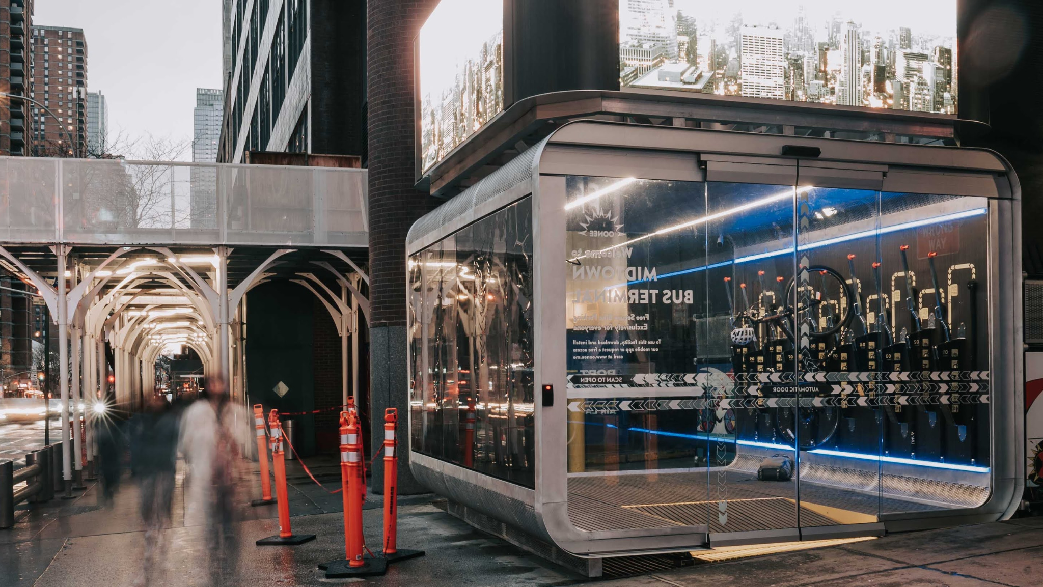 Modern bus shelter with glass walls in an urban setting